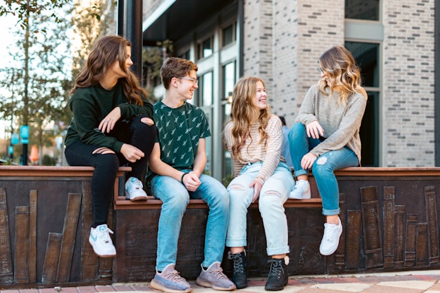 Young adults sitting together and smiling